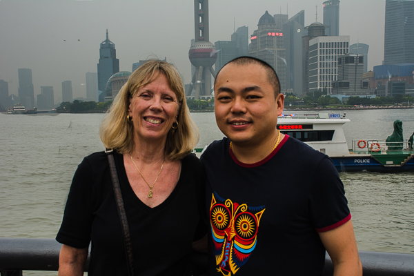 Rebecca and tour director Addison with the Huangpu River in the background in Shanghai.