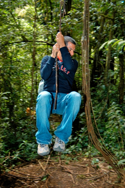 Nature guide Jimmy swinging from a vine at Monteverde.